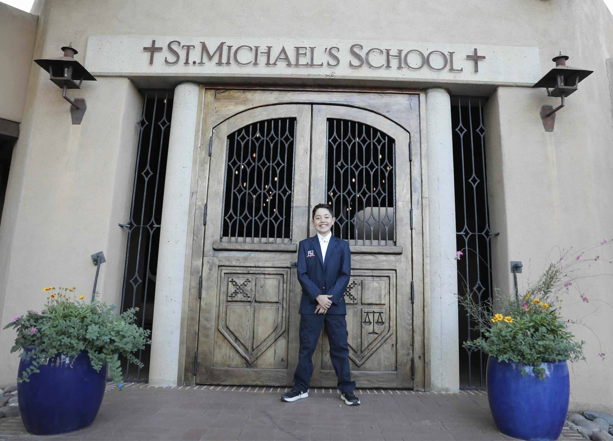 Student in front of school doors