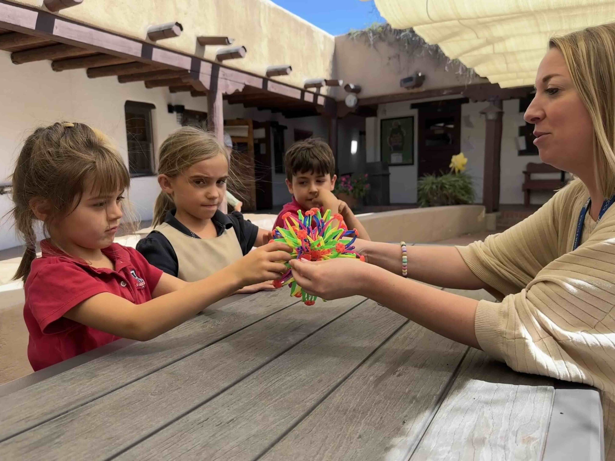 counselor with kids and toy